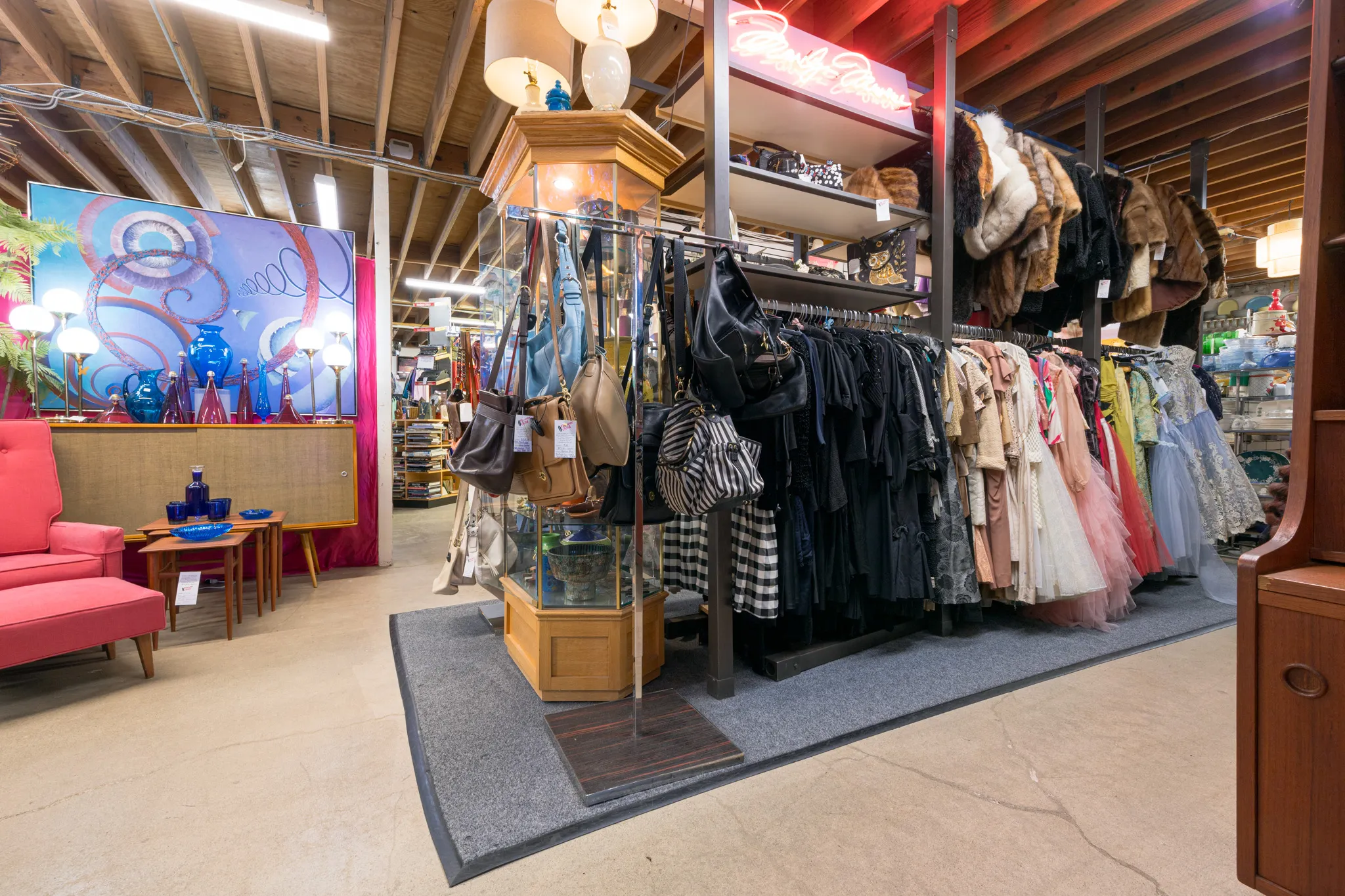 Vintage clothing store with colorful racks displayed.