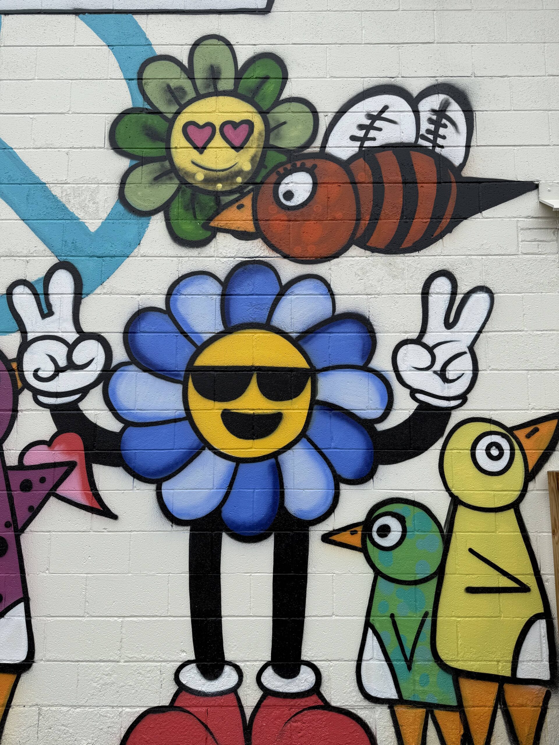 Colorful mural with smiling flower characters.