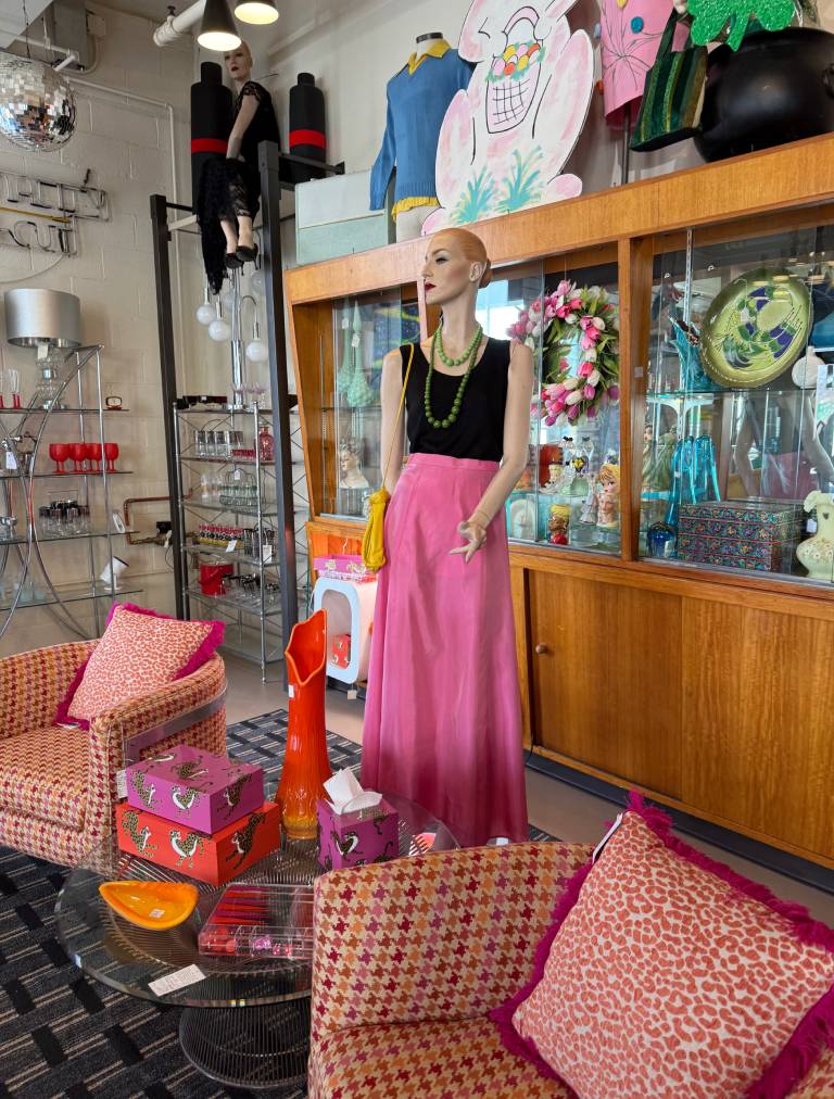 Vintage store with mannequin and retro decor.