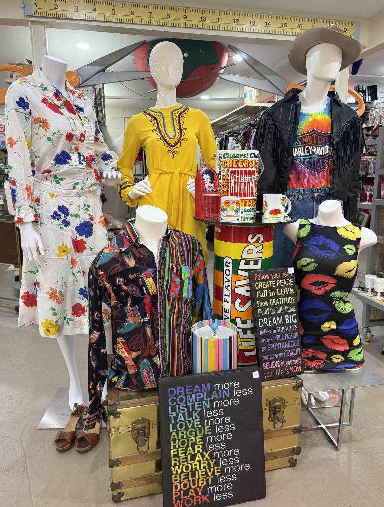 Colorful clothing display with inspirational quotes.