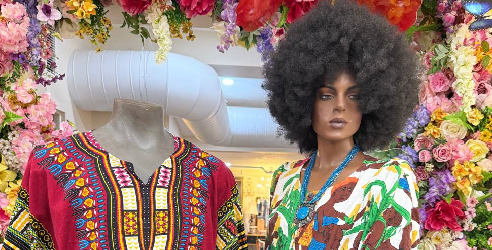Mannequins in colorful clothing, floral backdrop.