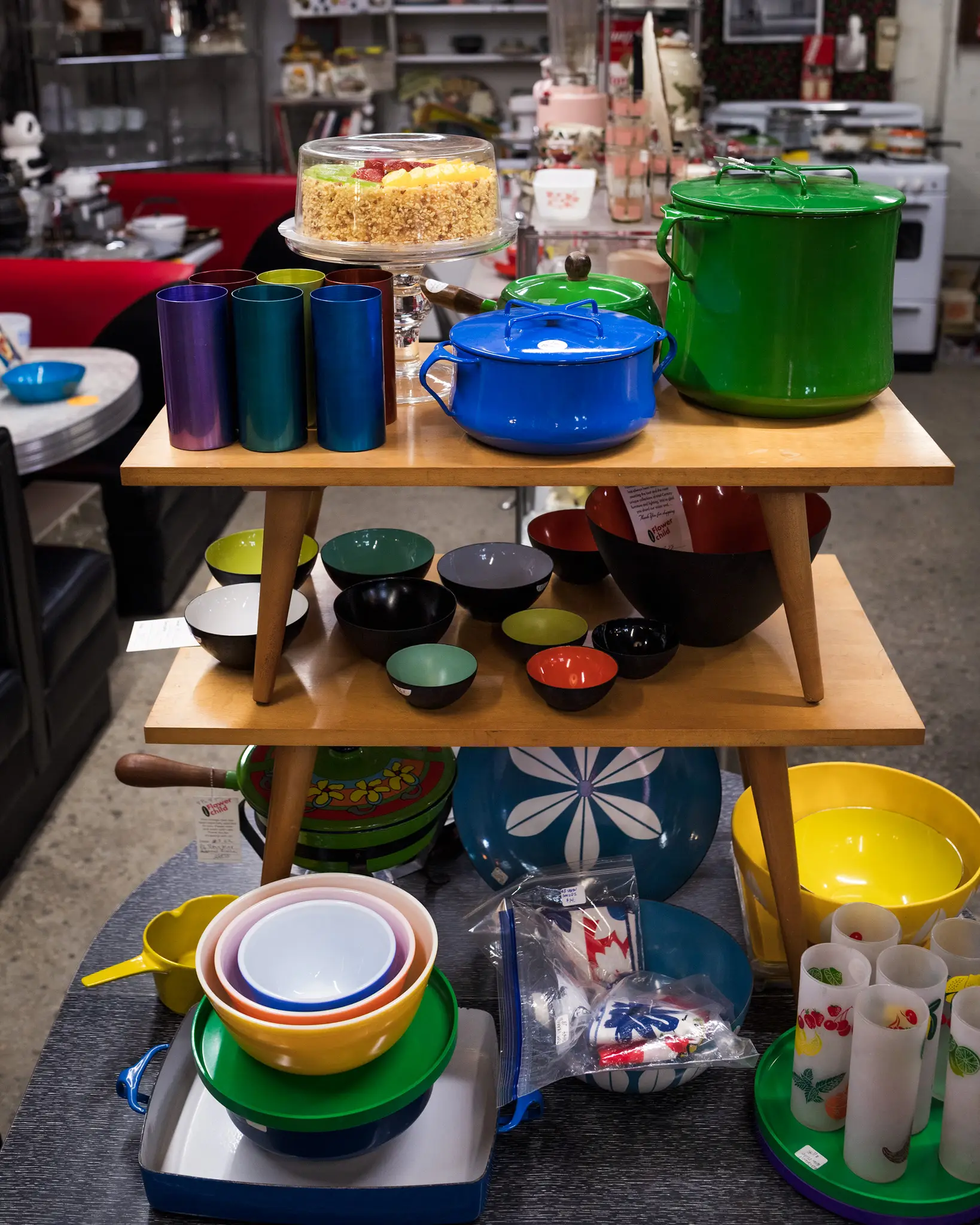 Vintage kitchenware display with colorful bowls and pots